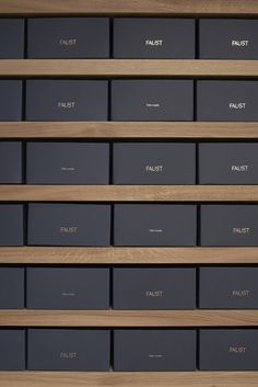 many boxes are stacked on top of each other in front of a wooden shelf filled with files