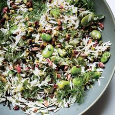 a bowl filled with rice, peas and sprouts on top of a table