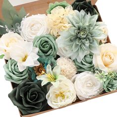 a box filled with lots of white and green flowers