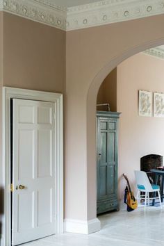 a living room filled with furniture next to a doorway