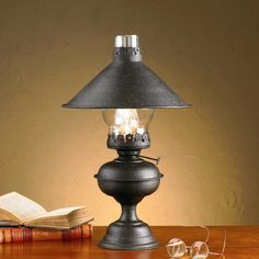 a lamp that is sitting on top of a table next to a book and glasses