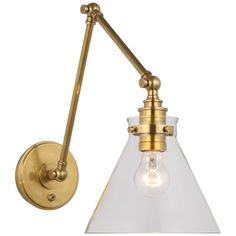 an antique brass finish wall light with clear glass shades and a bulb on the side