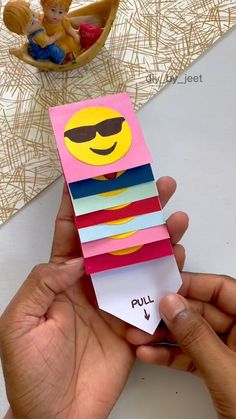 someone is holding up a card with a smiley face on it and the words pull are cut out