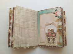 an open book with lace and flowers on it