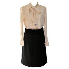 Offering a Silk Blouse and Wool Skirt ensemble. Skirt is 100% thick wool with a horizontal weave, and an all silk lining. Small pocket on right front. Skirt waist 28", length 22" approximate size 38-40. Cream white blouse with bow, three large mother-of-pearl buttons on front of blouse and one on each cuff. Length of blouse 26", sleeve 23". Approx EU size 38-40. Elegant Formal Wool Skirt Suit, Elegant Wool Skirt Suit For Formal Occasions, Formal Silk Skirt For Fall, Silk Skirt For Workwear, Elegant Wool Pleated Skirt, Elegant Wool Skirt For Formal Occasions, Luxury Silk Skirt For Workwear, Luxury Silk Skirt For Work, Silk Skirt For Workwear In Fall