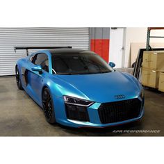 a blue sports car parked in a garage