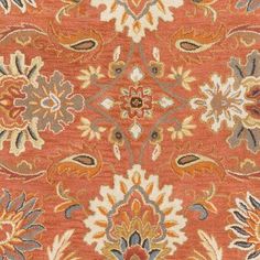 an orange rug with many different designs on it