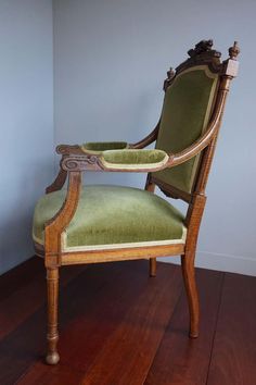 a green chair sitting on top of a wooden floor