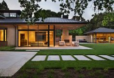 a modern house is lit up at night