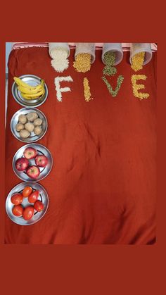 a table topped with bowls filled with fruit and veggies next to a sign that says live