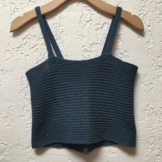 a cropped top hanging on a wooden hanger