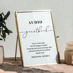 a sign sitting on top of a table next to a vase