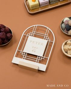 a table topped with bowls and trays filled with different types of food next to each other