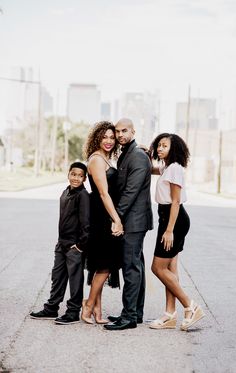 a family poses for a photo on the street