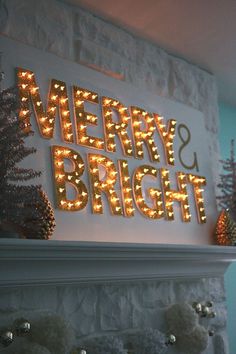 a lighted merry and bright sign on top of a fireplace