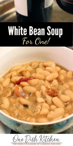 white bean soup in a blue bowl with the words, white bean soup for one