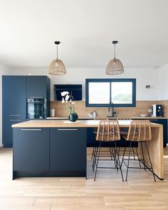 a kitchen with wooden floors and blue cabinets