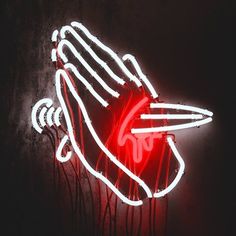 a red neon sign with a hand holding a surfboard in it's palm