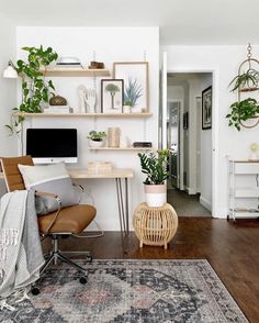 a living room filled with furniture and a flat screen tv sitting on top of a wooden table