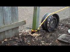 a tire that is on the ground next to a fence