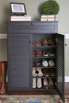 an open cabinet with shoes on it in a room