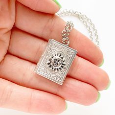 "Sun Book Locket Necklace Book Lover Jewelry -I make this necklace using an antique silver chain and book locket, and add a sun on the books cover -Pick any chain length from the dropdown menu- if you don't see your desired length, select \"custom\" and leave the length you need in the \"note to seller\" at checkout. I'm wearing an 18\" chain in the modeled photo, of the same locket with a triskelion on it to show size when worn -The pendant measures 1\" tall -Nickel free, lead free alloy metal Book Lover Jewelry, Book Locket Necklace, Sun Jewelry, Books Cover, Acorn Necklace, Lover Jewelry, Book Locket, Urn Jewelry, Celestial Jewelry