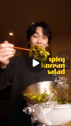 a man is eating food with chopsticks in front of him and the caption says spicy korean salad