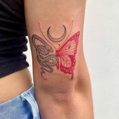 a woman's arm with a butterfly and snake tattoo on the left side of her arm