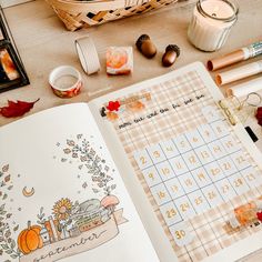 an open planner with autumn decorations and candles