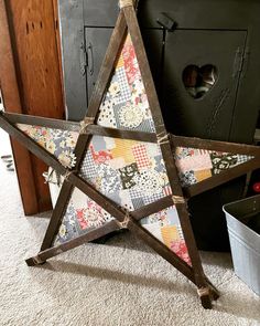 a wooden star is sitting on the floor