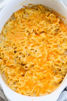 a white casserole dish filled with macaroni and cheese