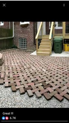 a brick patio with stairs and steps in the background