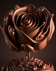 a chocolate flower on top of a piece of cake in the shape of a rose