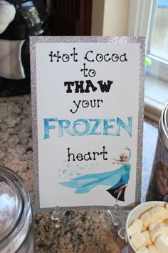 there is a sign that says hot cocoa to thaw your frozen heart on it