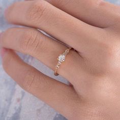 a woman's hand with a diamond ring on top of her finger and the word love written below it