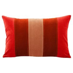 an orange and brown striped pillow on a white background