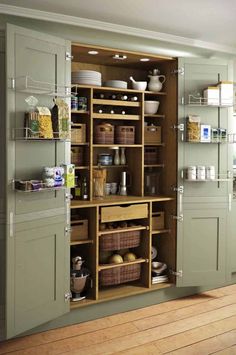 an open cabinet with baskets and other items in it