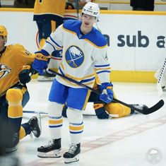 two hockey players are playing on the ice