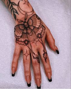 a woman's hand with tattoos on it