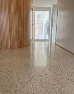 an empty room with wood paneling on the walls and floor is seen in this image