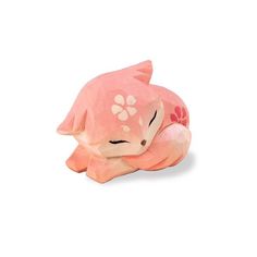 a small pink animal sleeping on top of a white surface