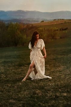 a woman in a white dress is posing for the camera with her legs spread out