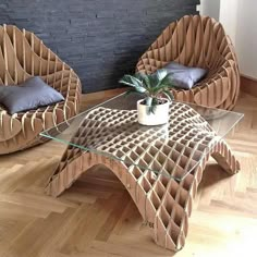 two chairs and a table with a potted plant on it