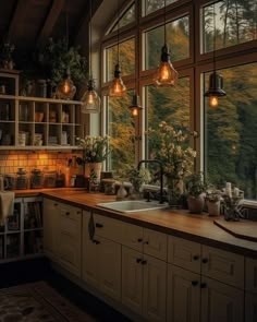 a kitchen filled with lots of counter top space next to a window covered in hanging lights