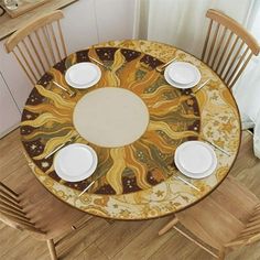 a round table with four chairs and plates on it in the middle of a room