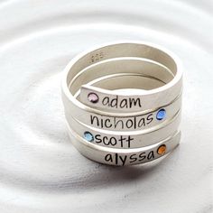 Four name wrap rings! This is made from one, solid piece of sterling silver that I have stamped, oxidized and hand set with 4 sparkling, Swarovski crystal elements. Available in many fonts, whole and half sizes 4-10, and finished in our signature brushed shine. This ring is available in many of our fonts. The fonts that will work on this piece are listed in the drop down menu, and pictured on the charts in the last 2 photographs. Please select your font choice and ring size from the drop down me Sterling Silver Hand Stamped Stackable Rings As Gift, Hand Stamped Sterling Silver Stackable Rings As Gift, Promise Rings In Stamped Sterling Silver, Unique Stamped Silver Rings, Adjustable Sterling Silver Engraved Ring, Nickel Free, Unique Hand Stamped Ring As Gift, Unique Hand Stamped Rings As A Gift, Unique Hand Stamped Rings As Gift, Nickel-free Engraved Sterling Silver Ring For Anniversary