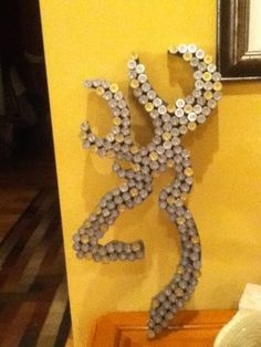 a sculpture made out of beads sitting on top of a table next to a mirror