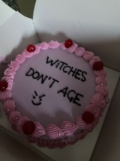 a birthday cake with the words witches don't age and cherries on it