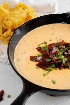 a bowl of soup with tortilla chips on the side