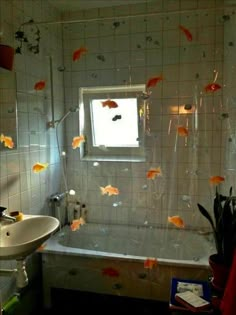 a bathroom with fish on the wall and bathtub